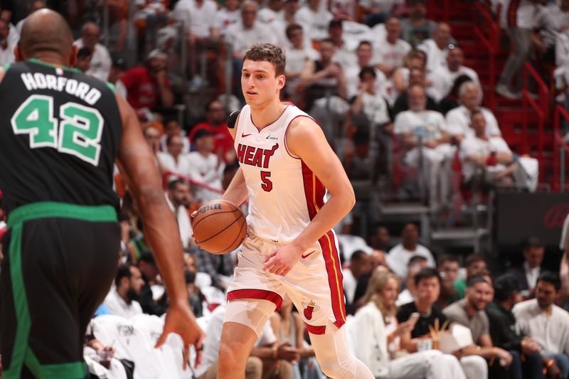 MIAMI, FL - APRIL 27: Nikola Jovic #5 of the Miami Heat dribbles the ball during the game against the Boston Celtics during Round 1 Game 3 of the 2024 NBA Playoffs on April 27, 2024 at Kaseya Center in Miami, Florida. NOTE TO USER: User expressly acknowledges and agrees that, by downloading and or using this Photograph, user is consenting to the terms and conditions of the Getty Images License Agreement. Mandatory Copyright Notice: Copyright 2024 NBAE (Photo by Issac Baldizon/NBAE via Getty Images)