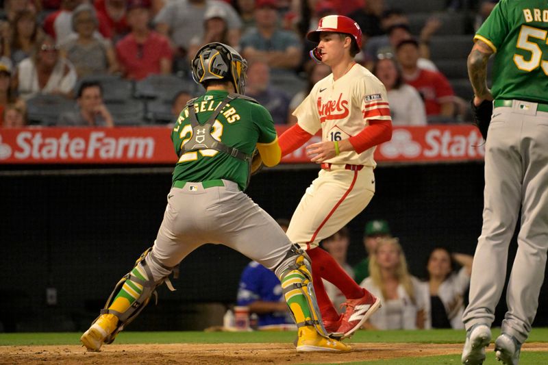Jun 24, 2024; Anaheim, California, USA;  Los Angeles Angels shortstop Zach Neto (9) is tagged out by Oakland Athletics catcher Shea Langeliers (23) in the sixth inning at Angel Stadium. Mandatory Credit: Jayne Kamin-Oncea-USA TODAY Sports