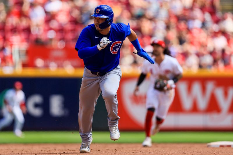 Jun 9, 2024; Cincinnati, Ohio, USA; Chicago Cubs designated hitter Seiya Suzuki (27) runs to third on a hit by third baseman Christopher Morel (not pictured) in the ninth inning against the Cincinnati Reds at Great American Ball Park. Mandatory Credit: Katie Stratman-USA TODAY Sports