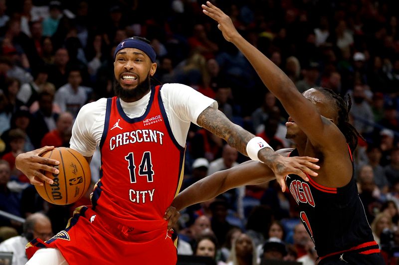 NEW ORLEANS, LOUISIANA - OCTOBER 23: Brandon Ingram #14 of the New Orleans Pelicans dribbles past Ayo Dosunmu #11 of the Chicago Bulls during the fourth quarter of an NBA game at Smoothie King Center on October 23, 2024 in New Orleans, Louisiana. NOTE TO USER: User expressly acknowledges and agrees that, by downloading and or using this photograph, User is consenting to the terms and conditions of the Getty Images License Agreement. (Photo by Sean Gardner/Getty Images)