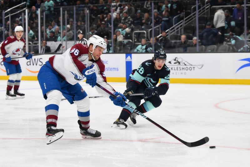 Nov 13, 2023; Seattle, Washington, USA; Colorado Avalanche right wing Mikko Rantanen (96) shoots the puck while defended by Seattle Kraken center Ryan Winterton (26) during the third period at Climate Pledge Arena. Mandatory Credit: Steven Bisig-USA TODAY Sports