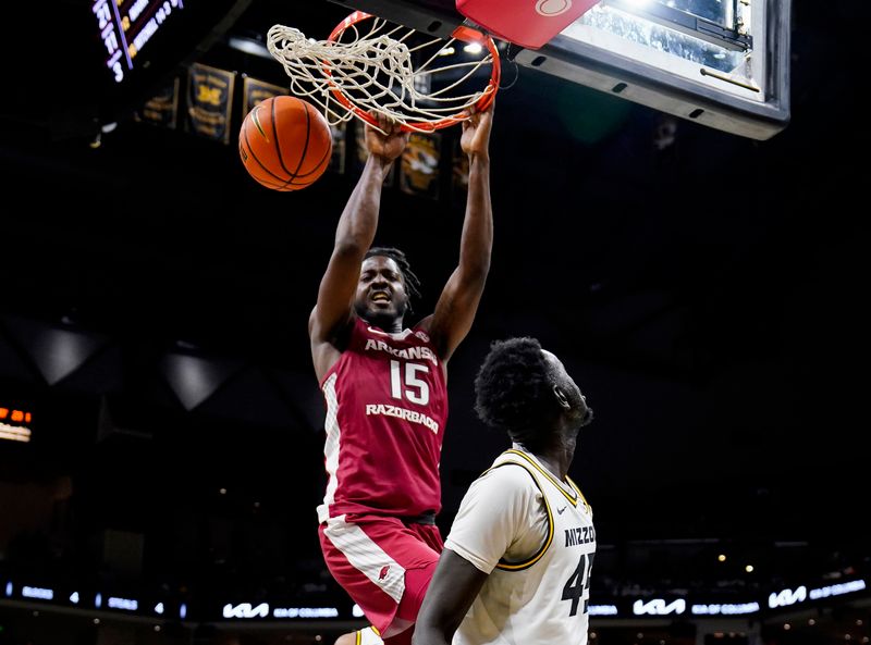 Jan 31, 2024; Columbia, Missouri, USA; Arkansas Razorbacks forward Makhi Mitchell (15) dunks the ball against Missouri Tigers center Mabor Majak (45) during the second half at Mizzou Arena. Mandatory Credit: Jay Biggerstaff-USA TODAY Sports