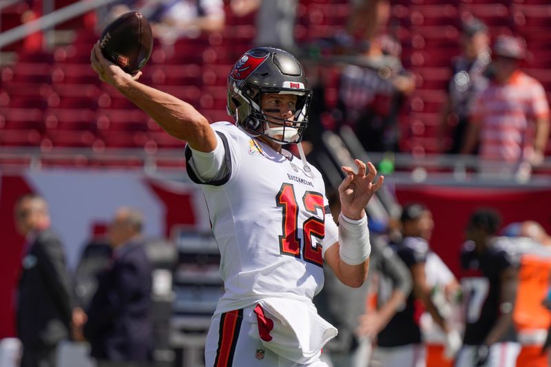 Tampa Bay Buccaneers quarterback Tom Brady warms up before the first half of an NFL football game between the Tampa Bay Buccaneers and the Atlanta Falcons Sunday, Oct. 9, 2022, in Tampa, Fla. (AP Photo/Chris O'Meara)