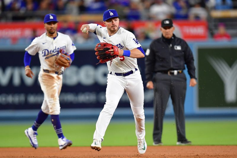 May 4, 2024; Los Angeles, California, USA; Los Angeles Dodgers second baseman Gavin Lux (9) throws to first for the out against Atlanta Braves shortstop Orlando Arcia (11) during the seventh inning at Dodger Stadium. Mandatory Credit: Gary A. Vasquez-USA TODAY Sports