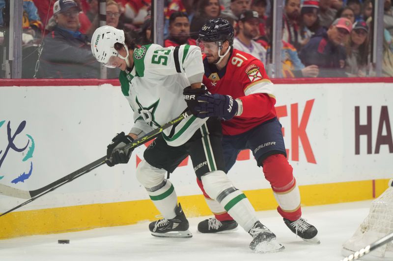 Dec 6, 2023; Sunrise, Florida, USA; Dallas Stars center Wyatt Johnston (53) and Florida Panthers defenseman Oliver Ekman-Larsson (91) battle for a loose puck during the first period at Amerant Bank Arena. Mandatory Credit: Jim Rassol-USA TODAY Sports