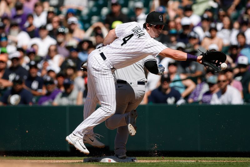 Jul 16, 2023; Denver, Colorado, USA; Colorado Rockies first baseman Michael Toglia (4) is unable to field a throw as New York Yankees second baseman Gleyber Torres (25) safely reaches first base in the ninth inning at Coors Field. Mandatory Credit: Isaiah J. Downing-USA TODAY Sports