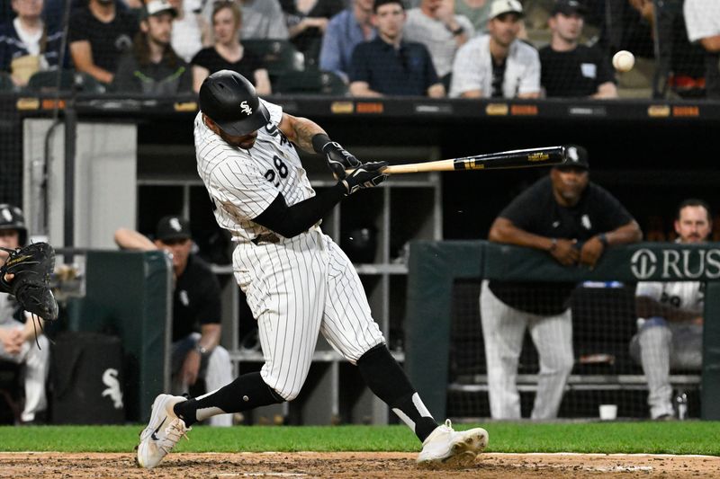 Jun 19, 2024; Chicago, Illinois, USA;  Chicago White Sox outfielder Tommy Pham (28) hits a single during the fifth inning against the Houston Astros at Guaranteed Rate Field. Mandatory Credit: Matt Marton-USA TODAY Sports