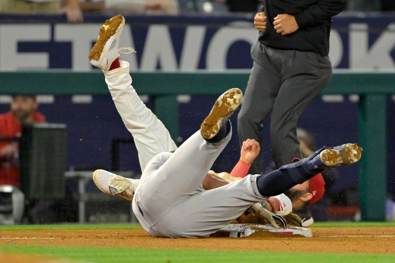 May 29, 2024; Anaheim, California, USA; New York Yankees shortstop Anthony Volpe (11) collides with Los Angeles Angels third baseman Luis Guillorme (15) on a triple and then scored on a throwing error by Los Angeles Angels second baseman Luis Rengifo (2) in the seventh inning at Angel Stadium. Mandatory Credit: Jayne Kamin-Oncea-USA TODAY Sports