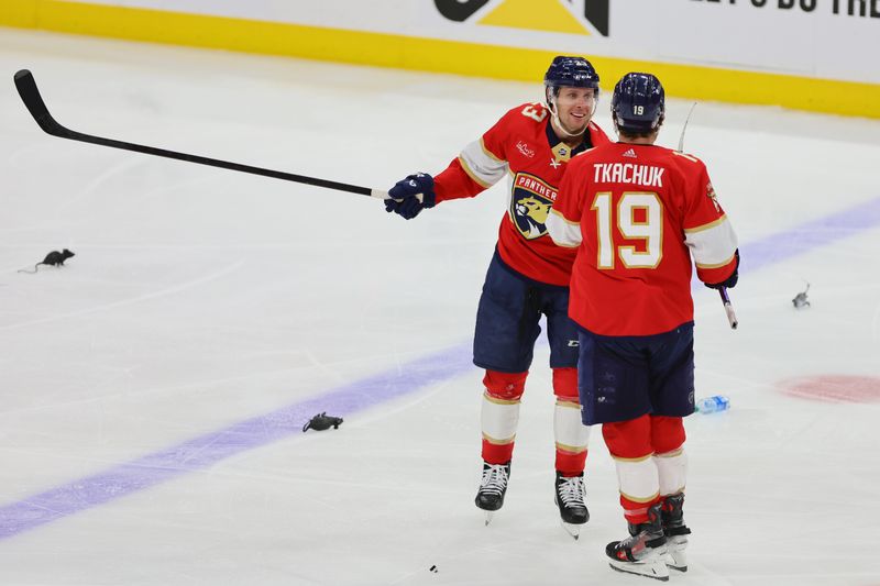 Apr 23, 2024; Sunrise, Florida, USA; Florida Panthers center Carter Verhaeghe (23) celebrates with left wing Matthew Tkachuk (19) after an overtime win against the Tampa Bay Lightning in game two of the first round of the 2024 Stanley Cup Playoffs at Amerant Bank Arena. Mandatory Credit: Sam Navarro-USA TODAY Sports