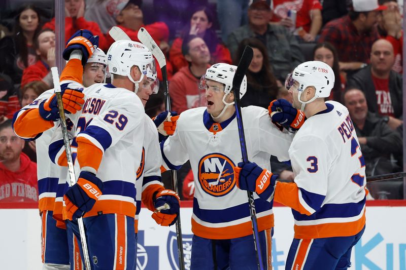 Feb 29, 2024; Detroit, Michigan, USA;  New York Islanders center Mathew Barzal (13) receives congratulations from teammates after scoring in the third period against the Detroit Red Wings at Little Caesars Arena. Mandatory Credit: Rick Osentoski-USA TODAY Sports