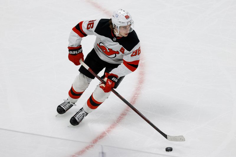 Feb 26, 2025; Denver, Colorado, USA; New Jersey Devils center Jack Hughes (86) controls the puck in the first period against the Colorado Avalanche at Ball Arena. Mandatory Credit: Isaiah J. Downing-Imagn Images
