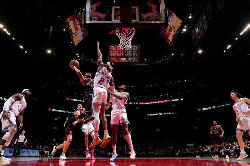 TORONTO, CANADA - MARCH 22:  Bruce Brown #11 of the Toronto Raptors drives to the basket during the game as Shai Gilgeous-Alexander #2 of the Oklahoma City Thunder plays defense on March 22, 2024 at the Scotiabank Arena in Toronto, Ontario, Canada.  NOTE TO USER: User expressly acknowledges and agrees that, by downloading and or using this Photograph, user is consenting to the terms and conditions of the Getty Images License Agreement.  Mandatory Copyright Notice: Copyright 2024 NBAE (Photo by Mark Blinch/NBAE via Getty Images)