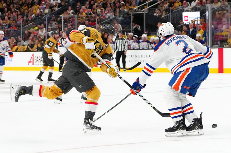 Apr 1, 2025; Las Vegas, Nevada, USA; Vegas Golden Knights center William Karlsson (71) shoots against the stick of Edmonton Oilers defenseman Evan Bouchard (2) during the second period at T-Mobile Arena. Mandatory Credit: Stephen R. Sylvanie-Imagn Images