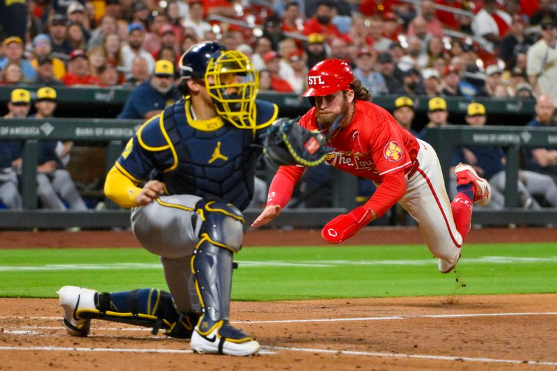 Apr 25, 2025; St. Louis, Missouri, USA;  St. Louis Cardinals second baseman Brendan Donovan (33) dives as he slides in at home as Milwaukee Brewers catcher William Contreras (24) receives the throw during the fourth inning at Busch Stadium. Mandatory Credit: Jeff Curry-Imagn Images