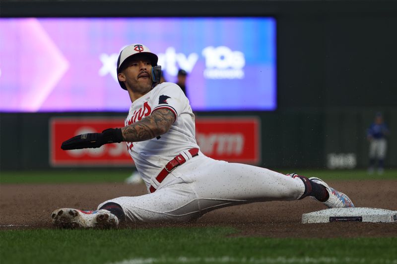 Oct 4, 2023; Minneapolis, Minnesota, USA; Minnesota Twins shortstop Carlos Correa (4) slides into third base in the eighth inning against the Toronto Blue Jays during game two of the Wildcard series for the 2023 MLB playoffs at Target Field. Mandatory Credit: Jesse Johnson-USA TODAY Sports