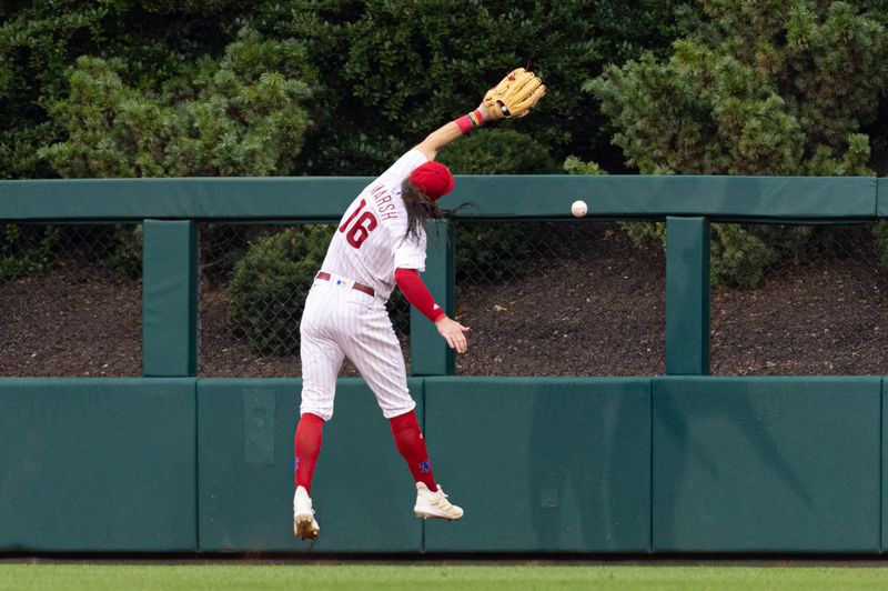 Aug 5, 2023; Philadelphia, Pennsylvania, USA; Philadelphia Phillies center fielder Brandon Marsh (16) is injured while attempting to catch the triple of Kansas City Royals second baseman Samad Taylor (not pictured) during the fifth inning at Citizens Bank Park. Mandatory Credit: Bill Streicher-USA TODAY Sports