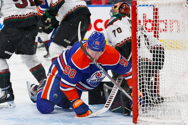 Apr 12, 2024; Edmonton, Alberta, CAN; Edmonton Oilers forward Corey Perry (90) crashes into Arizona Coyotes goaltender Karel Vejmelka (70) during the third period at Rogers Place. Mandatory Credit: Perry Nelson-USA TODAY Sports