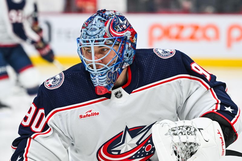 Mar 12, 2024; Montreal, Quebec, CAN; Columbus Blue Jackets goalie Elvis Merzlikins (90) looks on during warm-up before the game against the Montreal Canadiens at Bell Centre. Mandatory Credit: David Kirouac-USA TODAY Sports