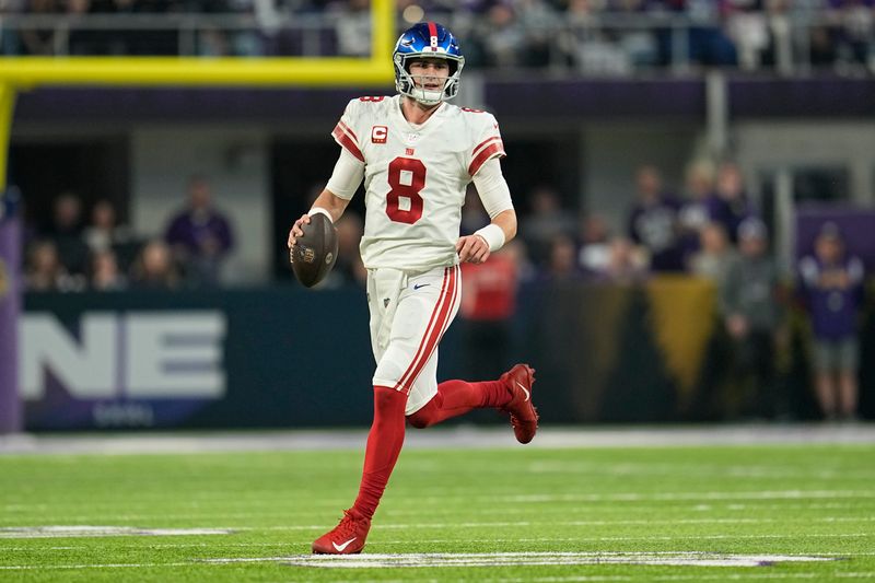 New York Giants quarterback Daniel Jones (8) runs down the field during the first half of an NFL wild-card football game against the Minnesota Vikings, Sunday, Jan. 15, 2023, in Minneapolis. (AP Photo/Abbie Parr)