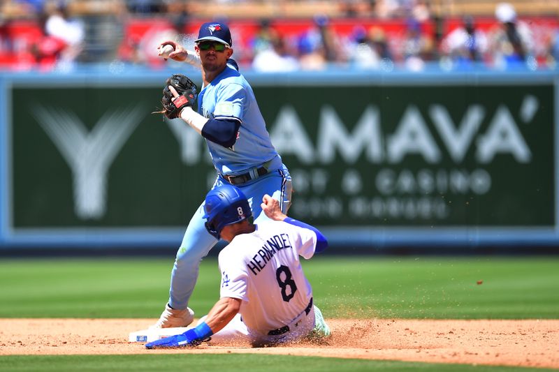 Jul 26, 2023; Los Angeles, California, USA; Los Angeles Dodgers second baseman Enrique Hernandez (8) is out at second as Toronto Blue Jays second baseman Cavan Biggio (8) throws to first for the out against Los Angeles Dodgers shortstop Miguel Rojas (11) during the fourth inning at Dodger Stadium. Mandatory Credit: Gary A. Vasquez-USA TODAY Sports