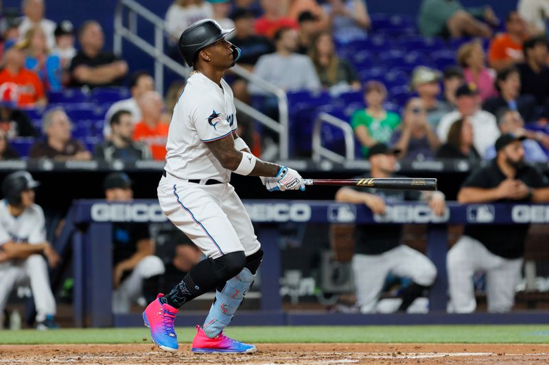 Jun 19, 2023; Miami, Florida, USA; Miami Marlins designated hitter Jorge Soler (12) watches after hitting a two-run home run against the Toronto Blue Jays during the third inning at loanDepot Park. Mandatory Credit: Sam Navarro-USA TODAY Sports