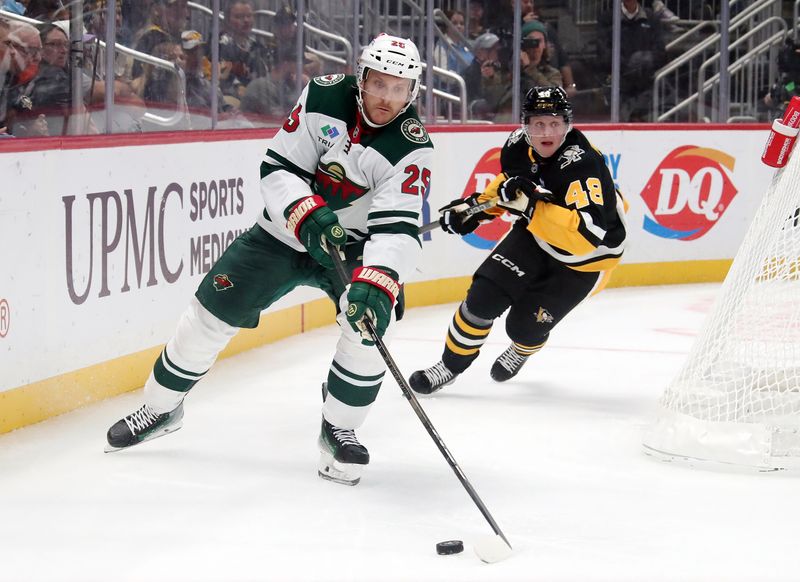 Oct 29, 2024; Pittsburgh, Pennsylvania, USA;  Minnesota Wild defenseman Jonas Brodin (25) chases the puck ahead of Pittsburgh Penguins right wing Valtteri Puustinen (48) during the third period  at PPG Paints Arena. Mandatory Credit: Charles LeClaire-Imagn Images