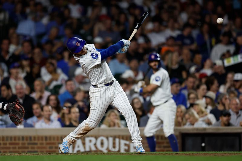 Sep 19, 2024; Chicago, Illinois, USA; Chicago Cubs outfielder Ian Happ (8) singles against the Washington Nationals during the fifth inning at Wrigley Field. Mandatory Credit: Kamil Krzaczynski-Imagn Images