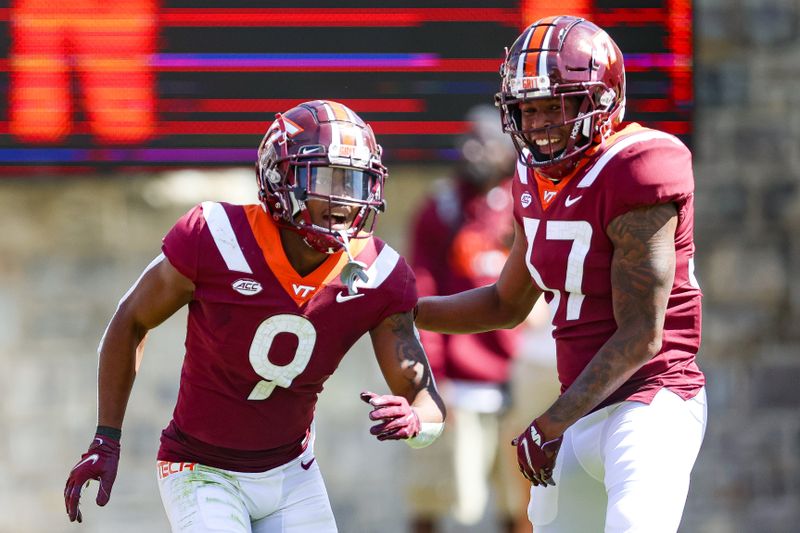 Sep 25, 2021; Blacksburg, Virginia, USA; Virginia Tech Hokies wide receiver Tayvion Robinson (9) and safety Tae Daley (17) react following Robinson   s touchdown run against the Richmond Spiders during the second quarter at Lane Stadium. Mandatory Credit: Ryan Hunt-USA TODAY Sports