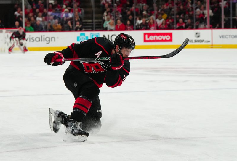 Jan 19, 2024; Raleigh, North Carolina, USA; Carolina Hurricanes defenseman Jaccob Slavin (74) takes a shot against the Detroit Red Wings during the third period at PNC Arena. Mandatory Credit: James Guillory-USA TODAY Sports