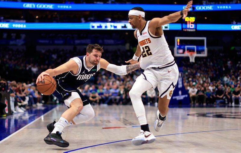 DALLAS, TX - MARCH 17: Luka Doncic #77 of the Dallas Mavericks handles the ball as Zeke Nnaji #22 of the Denver Nuggets defends in the second half at American Airlines Center on March 17, 2024 in Dallas, Texas. NOTE TO USER: User expressly acknowledges and agrees that, by downloading and or using this photograph, User is consenting to the terms and conditions of the Getty Images License Agreement. (Photo by Ron Jenkins/Getty Images)