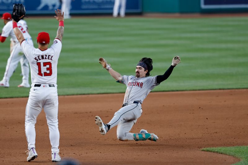 Jun 18, 2024; Washington, District of Columbia, USA; Arizona Diamondbacks outfielder Corbin Carroll (7) slides into third base with a triple ahead of a throw to Washington Nationals third base Nick Senzel (13) during the fifth inning at Nationals Park. Mandatory Credit: Geoff Burke-USA TODAY Sports