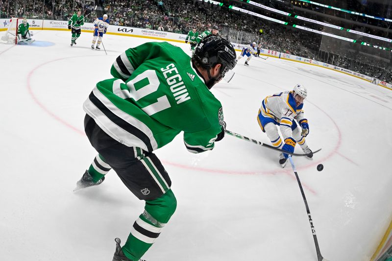 Apr 9, 2024; Dallas, Texas, USA; Dallas Stars center Tyler Seguin (91) clears the puck in front of Buffalo Sabres center Tyson Jost (17) during the third period at the American Airlines Center. Mandatory Credit: Jerome Miron-USA TODAY Sports