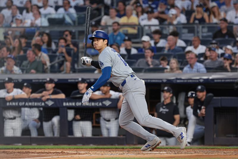 Jun 8, 2024; Bronx, New York, USA; Los Angeles Dodgers designated hitter Shohei Ohtani (17) hits an RBI single during the third inning against the New York Yankees at Yankee Stadium. Mandatory Credit: Vincent Carchietta-USA TODAY Sports