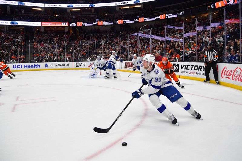 Dec 31, 2025; Anaheim, California, USA; Tampa Bay Lightning defenseman J.J. Moser (90) moves the puck against the Anaheim Ducks during the second period at Honda Center. Mandatory Credit: Gary A. Vasquez-Imagn Images