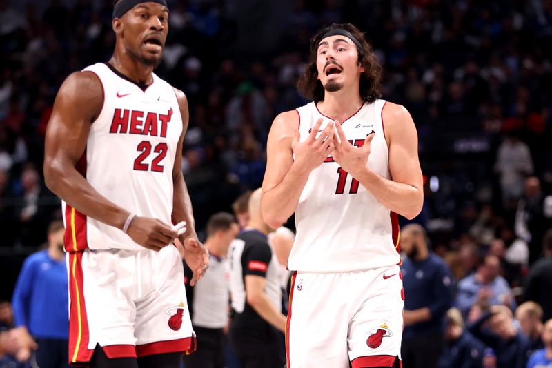 DALLAS, TEXAS - MARCH 07: Jimmy Butler #22 and Jaime Jaquez Jr. #11 of the Miami Heat talk in the first half of the game against the Dallas Mavericks at American Airlines Center on March 07, 2024 in Dallas, Texas.  NOTE TO USER: User expressly acknowledges and agrees that, by downloading and or using this photograph, User is consenting to the terms and conditions of the Getty Images License Agreement. (Photo by Tim Heitman/Getty Images)