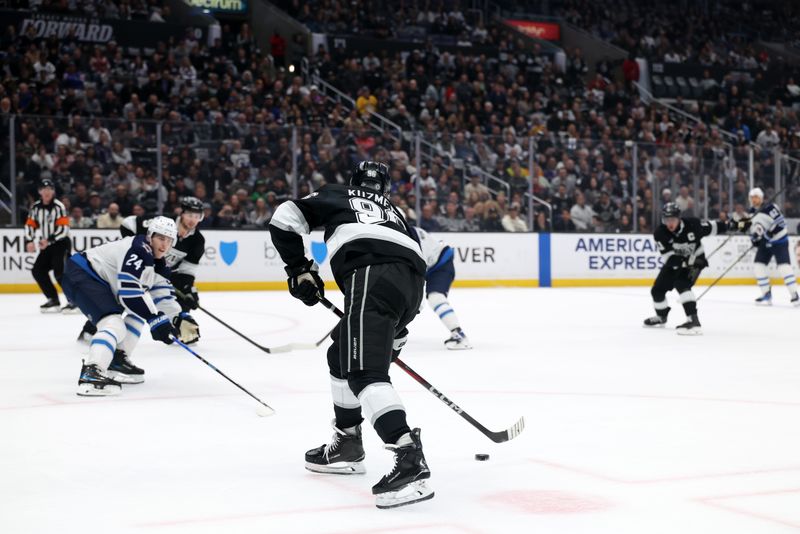 Apr 1, 2025; Los Angeles, California, USA;  Los Angeles Kings left wing Andrei Kuzmenko (96) looks to shoot the puck during the second period against the Winnipeg Jets at Crypto.com Arena. Mandatory Credit: Kiyoshi Mio-Imagn Images