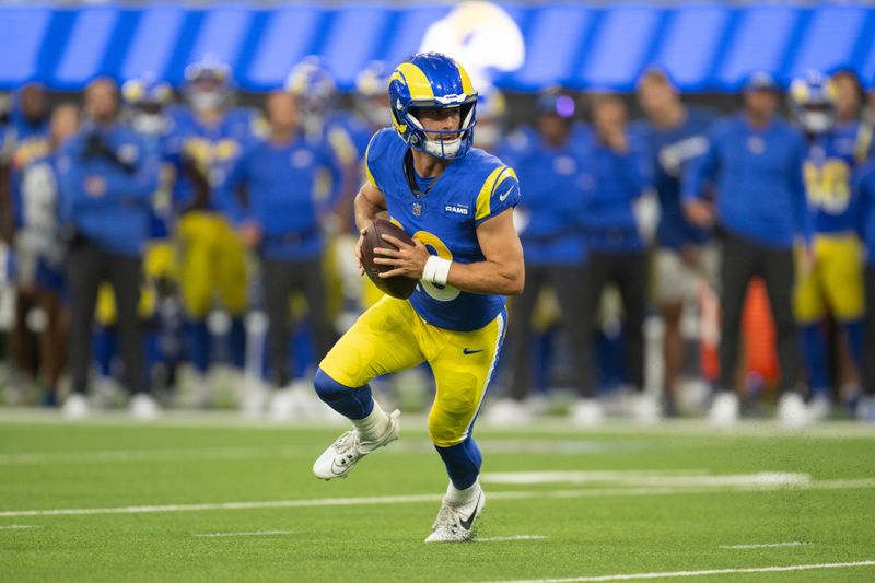 Los Angeles Rams quarterback Stetson Bennett (13) runs with the ball during an NFL preseason football game against the Los Angeles Chargers, Saturday, Aug. 12, 2023, in Inglewood, Calif. (AP Photo/Kyusung Gong)