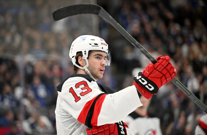 Jan 16, 2025; Toronto, Ontario, CAN;  New Jersey Devils forward Nico Hischier (13) look on in the third period against the Toronto Maple Leafs at Scotiabank Arena. Mandatory Credit: Dan Hamilton-Imagn Images