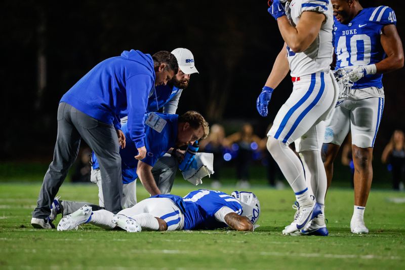 Oct 26, 2024; Durham, North Carolina, USA;  Southern Methodist Mustangs staff checks on Duke Blue Devils running back Marquise Collins (0) during the first half of the game against Duke Blue Devils at Wallace Wade Stadium. Mandatory Credit: Jaylynn Nash-Imagn Images