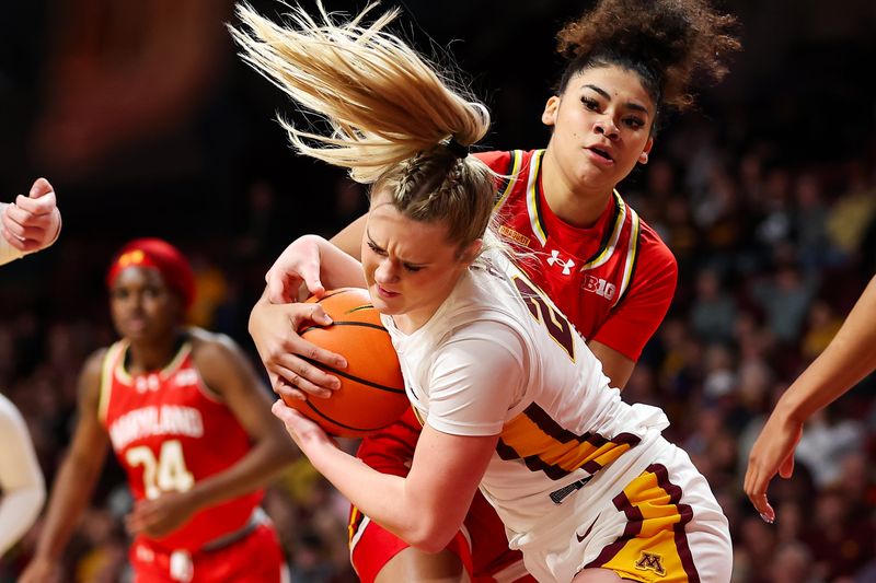 Jan 3, 2024; Minneapolis, Minnesota, USA; Minnesota Golden Gophers forward Mallory Heyer (24) and Maryland Terrapins guard Lavender Briggs (3) compete for the ball during the first half at Williams Arena. Mandatory Credit: Matt Krohn-USA TODAY Sports