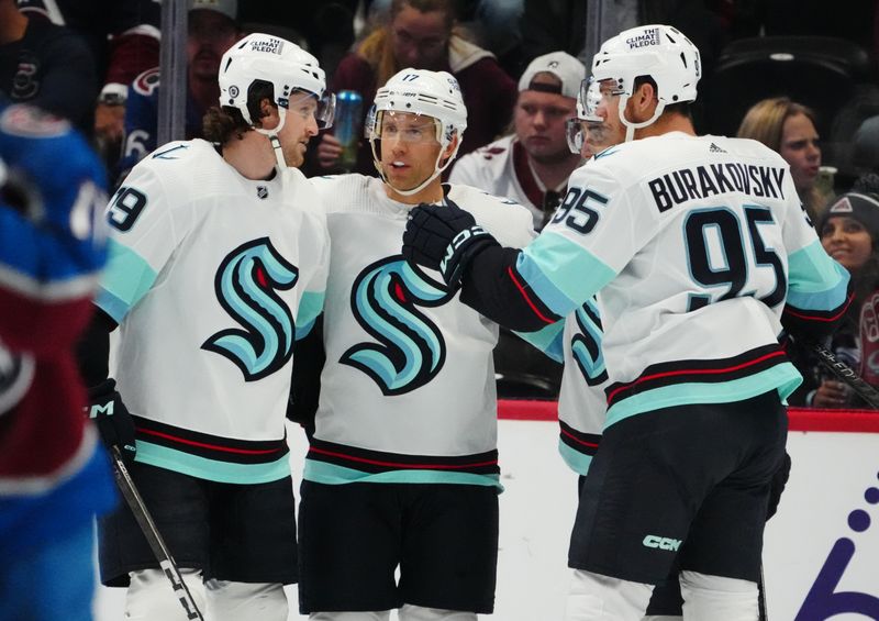 Oct 21, 2022; Denver, Colorado, USA; Seattle Kraken center Jaden Schwartz (17) (center) celebrates his gaol with left wing Jared McCann (19) and left wing Andre Burakovsky (95) in the second period against the Colorado Avalanche at Ball Arena. Mandatory Credit: Ron Chenoy-USA TODAY Sports