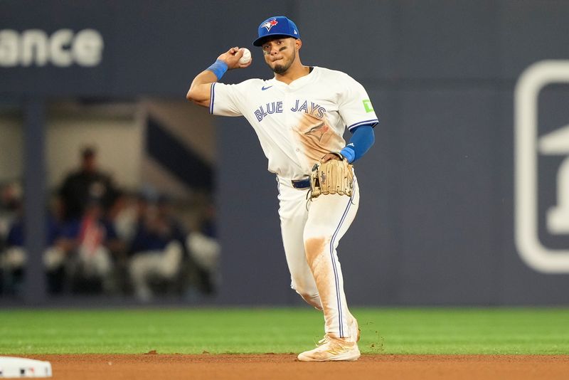 Jul 26, 2024; Toronto, Ontario, CAN; Toronto Blue Jays shortstop Leo Jimenez (49) throws out Texas Rangers center fielder Wyatt Langford (not pictured) at first base during the seventh inning at Rogers Centre. Mandatory Credit: John E. Sokolowski-USA TODAY Sports