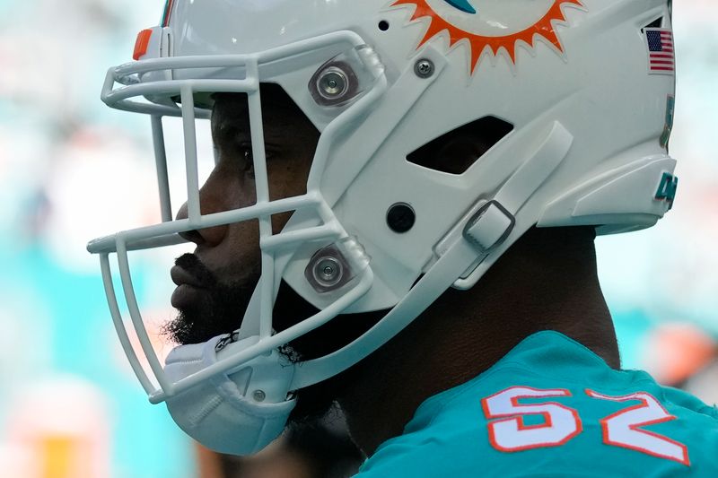 Miami Dolphins linebacker Elandon Roberts (52) walks on the field ahead of an NFL football game against the New York Jets, Sunday, Jan. 8, 2023, in Miami Gardens, Fla. (AP Photo/Rebecca Blackwell)