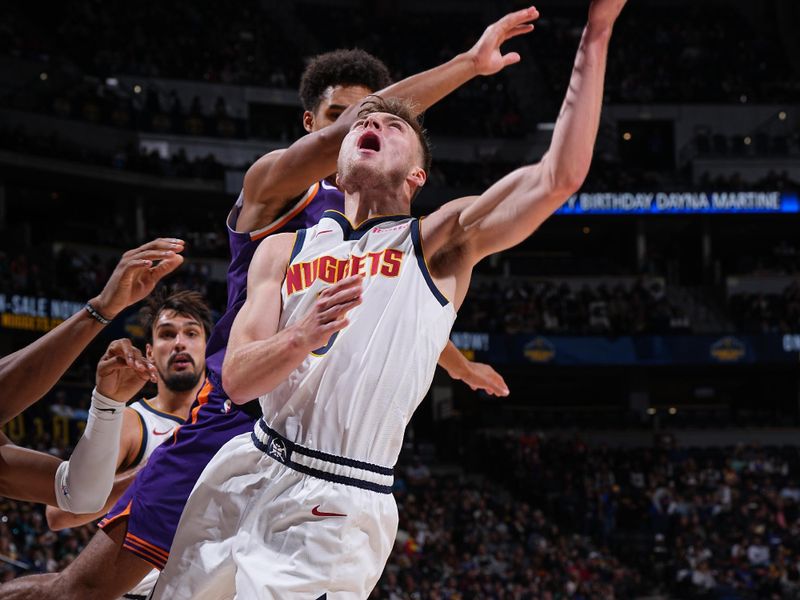 DENVER, CO - OCTOBER 13: Christian Braun #0 of the Denver Nuggets drives to the basket during the game against the Phoenix Suns on October 13, 2024 at Ball Arena in Denver, Colorado. NOTE TO USER: User expressly acknowledges and agrees that, by downloading and/or using this Photograph, user is consenting to the terms and conditions of the Getty Images License Agreement. Mandatory Copyright Notice: Copyright 2024 NBAE (Photo by Garrett Ellwood/NBAE via Getty Images)