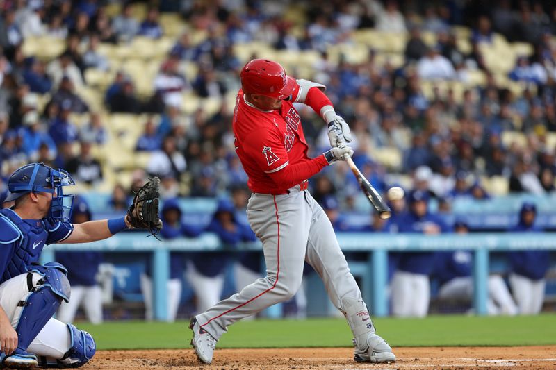 Mar 24, 2024; Los Angeles, California, USA;  Los Angeles Angels center fielder Mike Trout (27) hits a single during the third inning against the Los Angeles Dodgers at Dodger Stadium. Mandatory Credit: Kiyoshi Mio-USA TODAY Sports