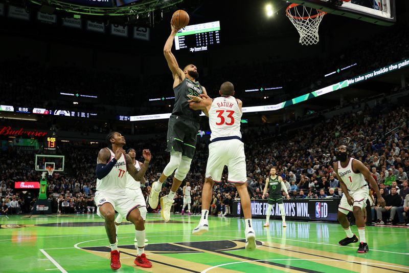 MINNEAPOLIS, MINNESOTA - NOVEMBER 29: Rudy Gobert #27 of the Minnesota Timberwolves attempts a dunk against Nicolas Batum #33 of the LA Clippers in the fourth quarter during the Emirates NBA Cup at Target Center on November 29, 2024 in Minneapolis, Minnesota. The Timberwolves defeated the Clippers 93-92. NOTE TO USER: User expressly acknowledges and agrees that, by downloading and or using this photograph, User is consenting to the terms and conditions of the Getty Images License Agreement. (Photo by David Berding/Getty Images)