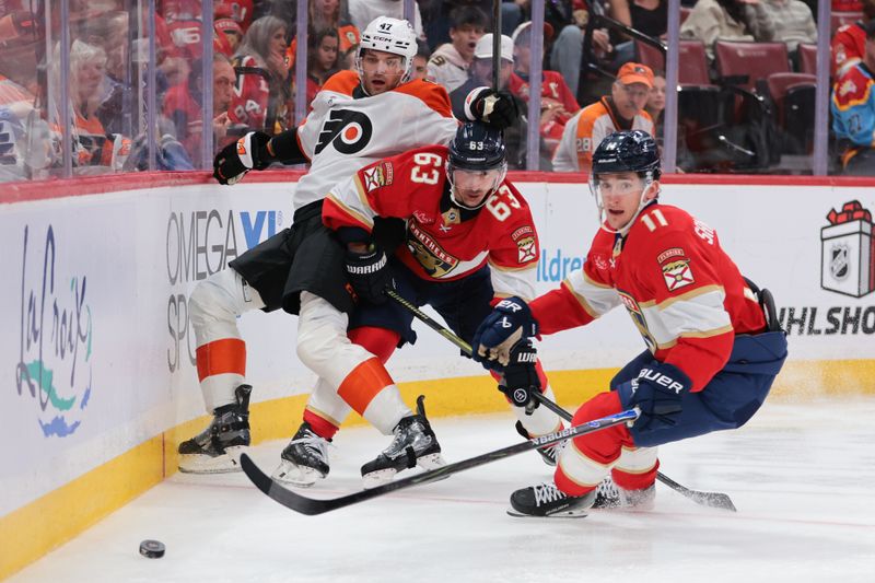 Nov 26, 2025; Sunrise, Florida, USA; Florida Panthers left wing Brad Marchand (63) protects the puck from Philadelphia Flyers defenseman Noah Juulsen (47) during the second period at Amerant Bank Arena. Mandatory Credit: Sam Navarro-Imagn Images