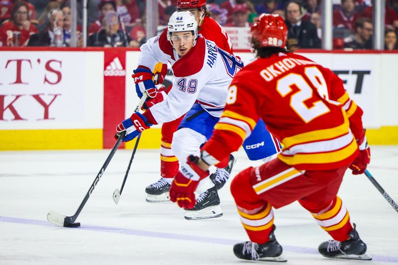 Mar 16, 2024; Calgary, Alberta, CAN; Montreal Canadiens left wing Rafael Harvey-Pinard (49) controls the puck against the Calgary Flames during the third period at Scotiabank Saddledome. Mandatory Credit: Sergei Belski-USA TODAY Sports