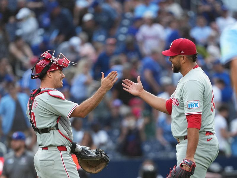 Sep 4, 2024; Toronto, Ontario, CAN; Philadelphia Phillies relief pitcher Carlos Estevez (53) and catcher J.T. Realmuto (10) celebrate the win against the Toronto Blue Jays at the end of the ninth inning at Rogers Centre. Mandatory Credit: Nick Turchiaro-Imagn Images