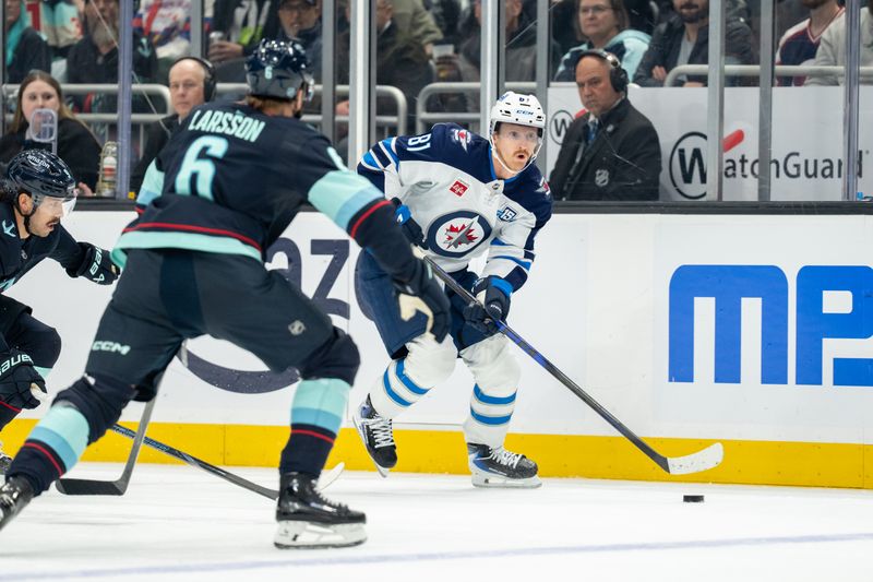 Nov 13, 2025; Seattle, Washington, USA; Winnipeg Jets forward Kyle Connor (81) skates against Seattle Kraken defenseman Adam Larsson (6) during the first period at Climate Pledge Arena. Mandatory Credit: Stephen Brashear-Imagn Images